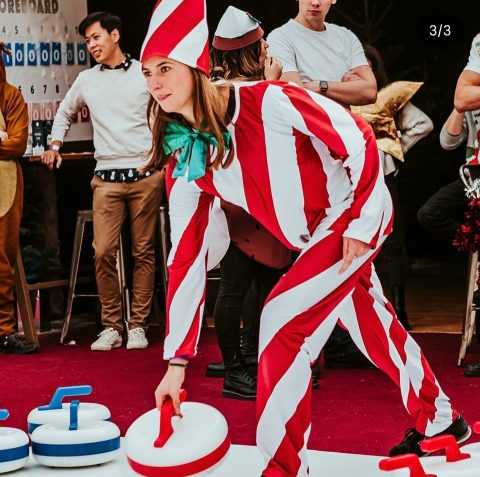 Woman curling dressed as a candy cane