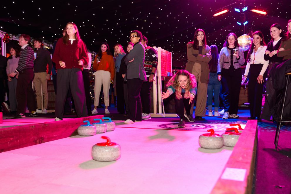 Guest curling in front of a crowd at Chelsea Winter Village